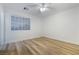 Bedroom featuring wood-look floors, ceiling fan, and window with blinds at 827 Happy Sparrow Ave, Henderson, NV 89052