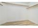 Walk-in closet with wood-look flooring, white walls, and wood closet rods at 827 Happy Sparrow Ave, Henderson, NV 89052