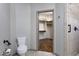 Well-lit bathroom featuring a toilet, a closet, and a tile shower with decorative trim at 854 Santa Maria Way, Mesquite, NV 89027