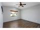 Neutral bedroom with hardwood floors, ceiling fan, and window views at 854 Santa Maria Way, Mesquite, NV 89027