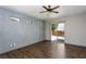 Stylish bedroom with hardwood flooring, ceiling fan, and sliding glass door at 854 Santa Maria Way, Mesquite, NV 89027