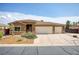 Inviting single-story home with well-manicured front yard and a three-car garage at 854 Santa Maria Way, Mesquite, NV 89027