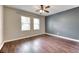 Bedroom features laminate flooring and two windows with bright, natural light at 8560 Osmerea Ct, Las Vegas, NV 89149
