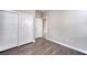 This bedroom has wood floors, white walls, and closet with sliding doors at 8560 Osmerea Ct, Las Vegas, NV 89149
