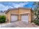 Home exterior features a two-car garage with white doors at 8560 Osmerea Ct, Las Vegas, NV 89149