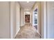 Bright hallway with tile flooring, leading to the kitchen and living room area at 8560 Osmerea Ct, Las Vegas, NV 89149