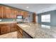 This kitchen has wood cabinets, granite countertops, and stainless steel appliances at 8560 Osmerea Ct, Las Vegas, NV 89149