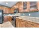 Well-equipped kitchen featuring wooden cabinets, granite countertops, and stainless steel appliances at 8560 Osmerea Ct, Las Vegas, NV 89149