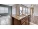 Kitchen island has a double sink and granite countertop, and open access to the living area at 8560 Osmerea Ct, Las Vegas, NV 89149