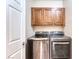 Laundry area with stainless steel washer and dryer and upper storage cabinets at 8560 Osmerea Ct, Las Vegas, NV 89149