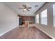 Spacious living room with wood flooring, open kitchen, and plentiful natural light at 8560 Osmerea Ct, Las Vegas, NV 89149