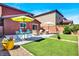 Well-maintained backyard with artificial grass, comfortable seating, and a patio perfect for entertaining at 9236 Keystone Ridge Ave, Las Vegas, NV 89148