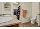 Well-lit bathroom with a single sink vanity, a toilet, and access to a walk in closet at 9236 Keystone Ridge Ave, Las Vegas, NV 89148
