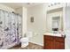 Well-lit bathroom featuring a vanity with sink, toilet and shower with curtain at 9236 Keystone Ridge Ave, Las Vegas, NV 89148