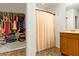 Bathroom featuring a single sink vanity, a shower with a curtain, and a walk in closet at 9236 Keystone Ridge Ave, Las Vegas, NV 89148