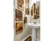 Quaint powder room features a pedestal sink and walls adorned with sports memorabilia at 9236 Keystone Ridge Ave, Las Vegas, NV 89148