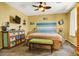Inviting bedroom with stylish decor, a ceiling fan, and a queen size bed with bench at 9236 Keystone Ridge Ave, Las Vegas, NV 89148