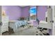 Bright bedroom showcasing a bed, window, and desk, all in a cozy and comfortable setting at 9236 Keystone Ridge Ave, Las Vegas, NV 89148