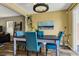 Cozy dining room with blue chairs, black table, modern light fixture and lots of natural light at 9236 Keystone Ridge Ave, Las Vegas, NV 89148