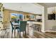 Inviting dining area with modern chandelier, adjacent to the open kitchen with breakfast bar seating at 9236 Keystone Ridge Ave, Las Vegas, NV 89148
