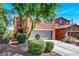 Charming two-story home featuring a well-maintained front yard, a driveway, and a two-car garage at 9236 Keystone Ridge Ave, Las Vegas, NV 89148