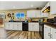 Updated kitchen with sleek appliances, black countertops, and white cabinetry for a modern feel at 9236 Keystone Ridge Ave, Las Vegas, NV 89148