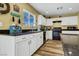 The kitchen features white cabinets, black appliances, wood-look flooring, and a window at 9236 Keystone Ridge Ave, Las Vegas, NV 89148