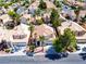Aerial view of a neighborhood featuring tile roofs and palm trees in a residential setting at 9413 Cedar Heights Ave, Las Vegas, NV 89134