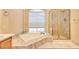 Bright bathroom featuring a large soaking tub, separate shower, and modern finishes at 9413 Cedar Heights Ave, Las Vegas, NV 89134