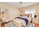 Cozy staged bedroom featuring a bed with neutral linens, a decorative rug, and ample closet space at 9413 Cedar Heights Ave, Las Vegas, NV 89134