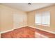 Unfurnished bedroom featuring wood floors, light beige walls, and a window with blinds at 9413 Cedar Heights Ave, Las Vegas, NV 89134