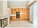 Open kitchen showing a fireplace, and cabinetry on tile floor at 9413 Cedar Heights Ave, Las Vegas, NV 89134