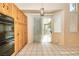 Spacious kitchen showing access to outdoor pool area with black oven, cabinets and tile floor at 9413 Cedar Heights Ave, Las Vegas, NV 89134
