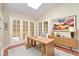 Bright office with a skylight, French doors, hardwood floors, and a modern desk with matching dresser at 9413 Cedar Heights Ave, Las Vegas, NV 89134