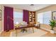 Functional home office with a large window, built-in shelving, and ample desk space at 9413 Cedar Heights Ave, Las Vegas, NV 89134