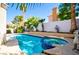 Beautiful pool and spa surrounded by lush landscaping and a privacy wall at 9413 Cedar Heights Ave, Las Vegas, NV 89134