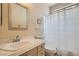 Cozy bathroom featuring a shower over tub, a single sink vanity, and neutral decor at 9622 Emeraude Ave, Las Vegas, NV 89147