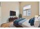 Vaulted ceiling bedroom featuring wood floors, a queen bed, and plenty of natural light at 9622 Emeraude Ave, Las Vegas, NV 89147