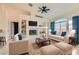 Bright living room features plush seating, fireplace, and a large arched window with natural light at 9622 Emeraude Ave, Las Vegas, NV 89147