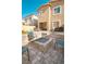 Backyard with gas fire pit, lush synthetic grass, and ample patio seating space at 9934 Iron Creek Ave, Las Vegas, NV 89178