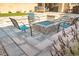 Backyard view featuring custom paver patio, gas fire pit, and comfortable seating at 9934 Iron Creek Ave, Las Vegas, NV 89178