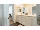 Bathroom featuring a double vanity, quartz countertops, framed mirrors, and modern finishes at 9934 Iron Creek Ave, Las Vegas, NV 89178