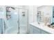 Bright bathroom featuring a glass enclosed shower, white subway tile and a white vanity at 9934 Iron Creek Ave, Las Vegas, NV 89178