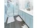 Modern bathroom with dual sinks, gray wood floors, white cabinets and large glass shower at 9934 Iron Creek Ave, Las Vegas, NV 89178