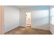 Bedroom view showcasing neutral carpet and en-suite bathroom entrance at 9934 Iron Creek Ave, Las Vegas, NV 89178