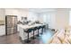 Open-concept kitchen featuring a large island with bar seating, stainless steel appliances, and white cabinetry at 9934 Iron Creek Ave, Las Vegas, NV 89178