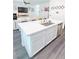 Kitchen island with a stainless steel sink, dishwasher, and lots of cabinet space at 9934 Iron Creek Ave, Las Vegas, NV 89178