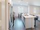 Well-lit modern kitchen with island, stainless steel appliances, and an adjacent dining area at 9934 Iron Creek Ave, Las Vegas, NV 89178