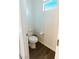 Small powder room with modern toilet and hardwood floors in neutral colors at 9934 Iron Creek Ave, Las Vegas, NV 89178