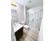 Bathroom with glass shower, white tile, and dark vanity at , Las Vegas, NV 89148